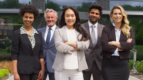 Portrait-Of-Smiling-Multi-Cultural-Business-Team-Outside-Modern-Office-Building