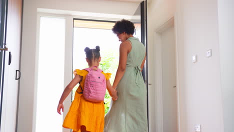 Mother-At-Home-Helping-Daughter-Getting-Ready-And-Leaving-To-Go-To-School-Together