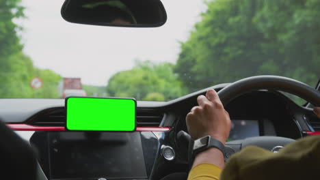 Close-Up-Of-Female-Driver-With-Hands-Free-Unit-For-Green-Screen-Mobile-Phone-Mounted-On-Dashboard
