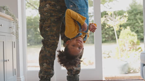Close-Up-Of-Loving-Army-Father-In-Uniform-Home-On-Leave-Holding-Daughter-Upside-Down