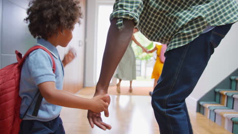 Parents-At-Home-Helping-Children-Get-Ready-And-Leave-As-Family-Go-To-School-Together