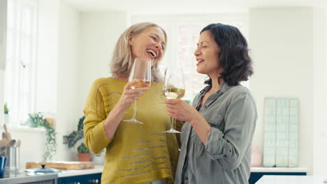 Loving-Same-Sex-Mature-Female-Couple-Celebrating-With-Glass-Of-Wine-At-Home-Together