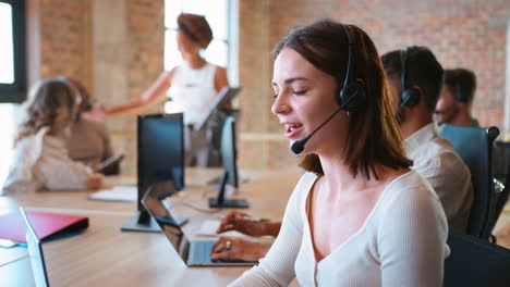 Portrait-Of-Businesswoman-In-Multi-Cultural-Business-Team-Wearing-Headset-In-Customer-Support-Centre