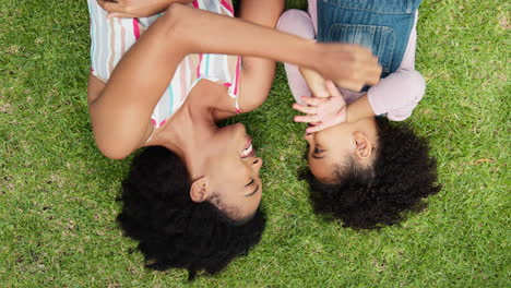 Overhead-Shot-Of-Smiling-Mother-And-Daughter-Lying-On-Grass-In-Garden-Together