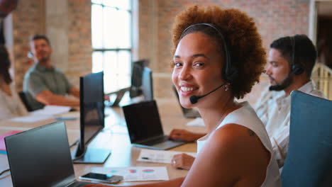 Portrait-Of-Businesswoman-In-Multi-Cultural-Business-Team-Wearing-Headset-In-Customer-Support-Centre