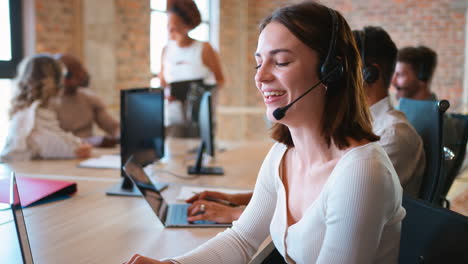 Businesswoman-In-Business-Team-Wearing-Headset-In-Customer-Support-Centre