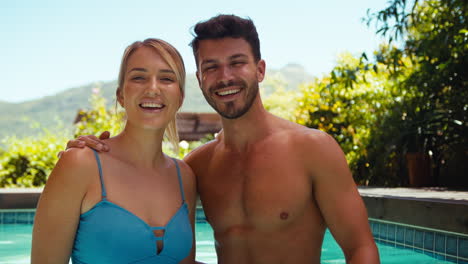 Portrait-Of-Smiling-Couple-On-Holiday-In-Swimming-Pool