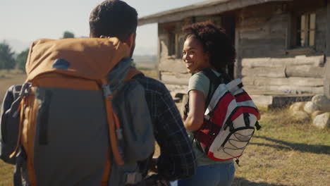 Rear-View-Of-Group-Of-Friends-With-Backpacks-Hiking-In-Countryside-Together