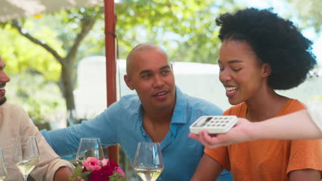 Woman-Making-Contactless-Payment-At-Outdoor-Bar-Or-Restaurant-Using-Credit-Or-Debit-Card