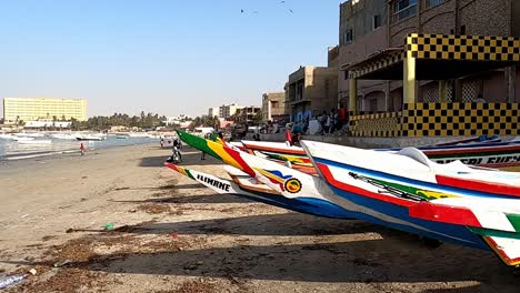 Colorful-Fishing-Dugout-Boats-On-The-Beach-In-Senegal,-West-Africa