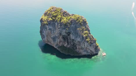 High-altitude-aerial-of-famous-ocean-limestone-cliff,-Koh-Poda,-Krabi