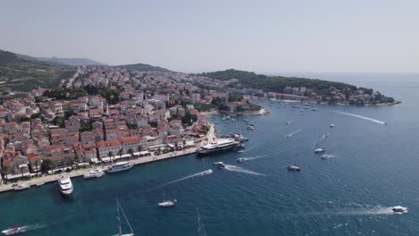 Busy-waterfront-of-Hvar-harbor,-cityscape-background