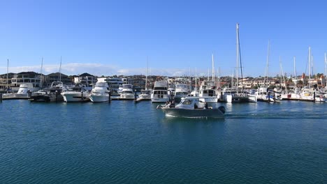 Speedboat-making-it’s-way-slowly-past-a-row-of-yachts-at-Mindarie-Marina