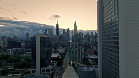 Spirit-of-Progress-statue,-colorful-evening-in-Chicago---descending,-drone-shot