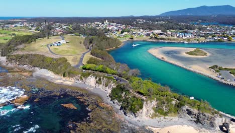 Drone-aerial-landscape-shot-of-Narooma-channel-headland-carpark-lookout-Wagonga-beach-sea-ocean-Inlet-South-Coast-NSW-Australia-travel-tourism-4K