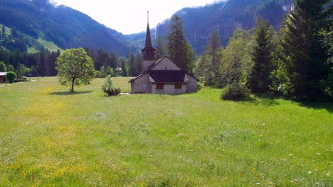 Old-church-in-the-valley-surrounded-by-magnificent-Swiss-Alps-mountains