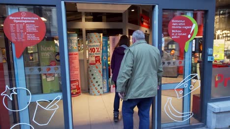 An-entrance-to-Delhaize-store-network-with-customers-going-in-through-the-sliding-glass-door