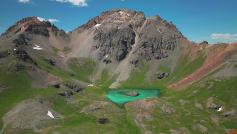 Cinematic-aerial-drone-high-elevation-dreamy-heavenly-Island-Lake-Silverton-Ice-Lake-Basin-unreal-Caribbean-aqua-blue-Silverton-Colorado-lush-green-summer-snow-melting-Rocky-Mountains-slowly-up-motion