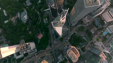 Aerial-top-down-shot-showing-traffic-on-highway-near-Bank-of-China-in-downtown-Hong-Kong-City-at-sunset-time