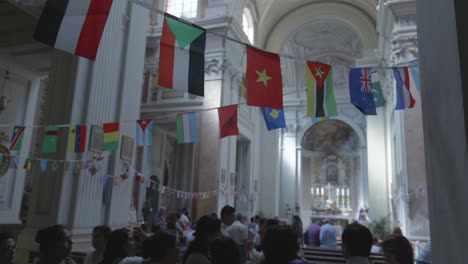 Flags-of-all-countries-in-the-world-hanging-on-a-rope-in-a-church-in-honour-of-the-start-of-"Lord-of-Miracles"-commemoration-among-the-Peruvian-community