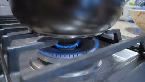 turn-down-the-fire-of-gas-stove-range-in-kitchen