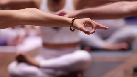 Full-HD-video-During-yoga-session,-a-group-of-people-sitting-cross-legged-improve-self-awareness,-increase-clarity-of-mind,-gyan-mudra-pose