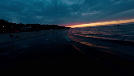 FPV-drone-flying-fast-over-the-waves-of-the-Baltic-Sea-in-Poland-at-sunset