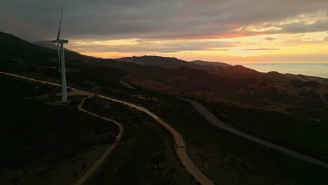 Descending-drone-shot-during-sunset-with-windmill-along-the-coast-of-Spain