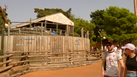 Pan-shot-of-Tomahawk-wooden-coaster-entrance-in-Port-Aventura-amusement-park-in-Salou,-Spain-on-a-sunny-day