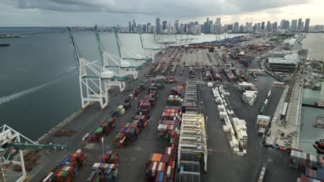 aerial-of-commercial-port-in-south-beach-at-sunset-with-cargo-boat-crane-container-for-shipping-import-and-export