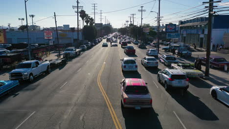 Aerial-view-tracking-cars-hydraulic-jumping-on-the-streets-of-Los-Angeles