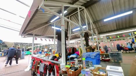 POV-looking-around-busy-British-flea-market-at-variety-of-disposable-unwanted-objects-for-a-cheap-bargain