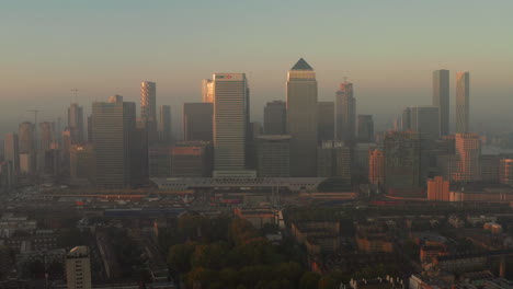 Rising-aerial-shot-of-Canary-Wharf-from-Poplar-docklands-at-sunrise