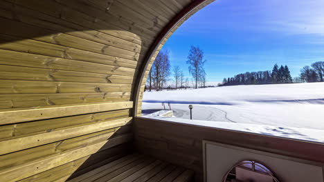 Outdoor-Wooden-Barrel-Sauna-Looking-Outside-at-Winter-Snow-TImelapse