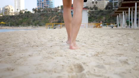 Adult-walking-across-sand-captured-in-slow-motion