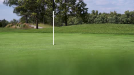 Golfer-hitting-a-golf-ball-onto-the-green-on-a-golf-course