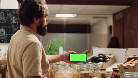 Man-uses-mockup-phone-in-bio-supermarket