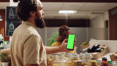 Man-uses-green-screen-phone-in-food-shop