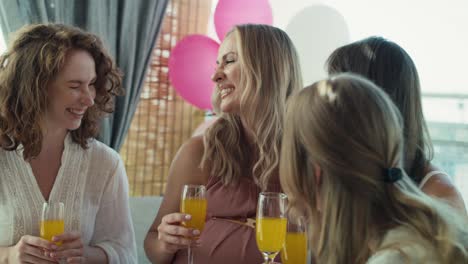 Group-of-caucasian-women-drinking-cocktails-at-baby-shower.