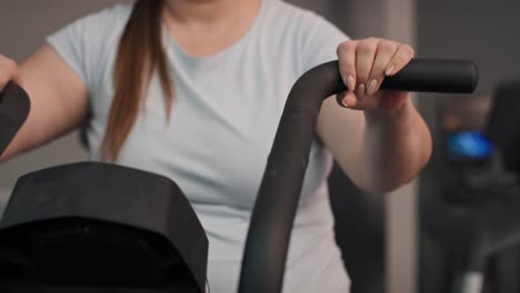 Close-up-of-overweight-woman-doing-training-at-the-gym.