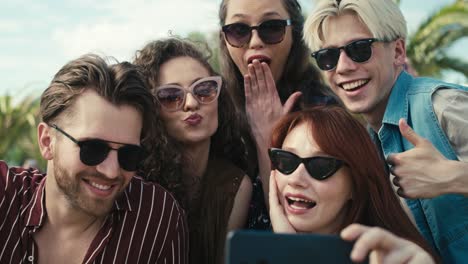 Group-of-caucasian-friends-making-funny-faces-for-a-selfie-on-music-festival.