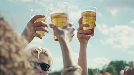 Group-of-caucasian-friends-make-toasting-beer-at-festival
