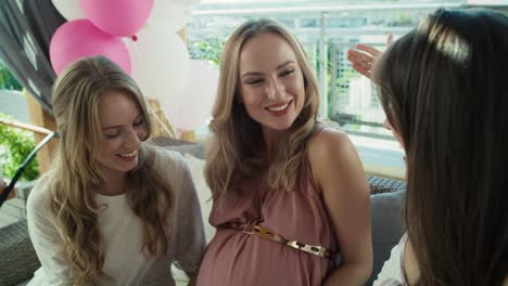 Group-of-women-talking-by-video-call-with-absent--friend-at-baby-shower.