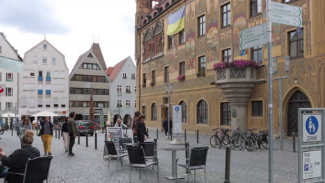 People-Walking-In-The-Marktplatz-Near-The-Ulmer-Rathaus,-Town-Hall-In-Ulm,-Germany---static