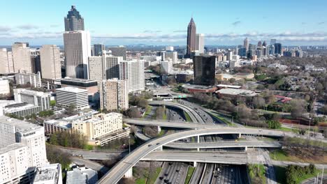 Drone-shot-of-Downtown-connector-highway-traffic-and-overpass-with-the-view-of-iconic-skyscrapers-Truist-Plaza-and-Bank-of-America-Plaza-in-the-background