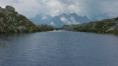 Wonderful-mountain-landscape-by-Campagneda-lakes,-tilt-up-reveal-Alps-peaks