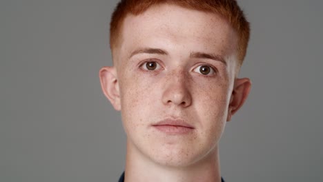 Close-up-portrait-of-serious-red-head-caucasian-teenage-man.