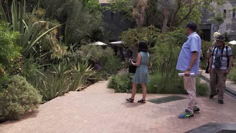Entdecken-Sie-Die-äußere-Schönheit-Von-Le-Jardin-Secret-In-Marrakesch,-Einem-Wahrzeichen-Palast-Mit-Atemberaubendem-Dekor,-Wasserspielen-Und-üppigen-Pflanzen,-Während-Touristen-Die-Aussicht-Genießen