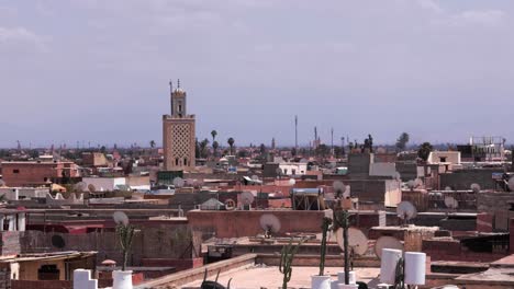 A-panoramic-view-featuring-a-renowned-mosque-landmark-in-Marrakesh,-Morocco,-with-intricate-architectural-ornamentation,-a-cultural-heritage-within-the-historic-medina