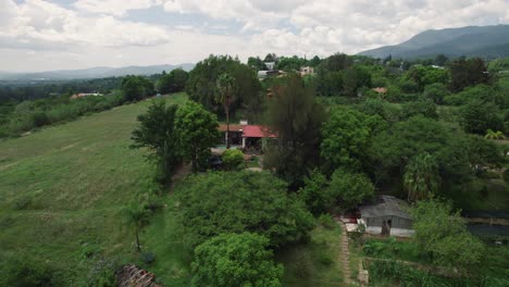 Distancing-aerial-of-small-house-hidden-in-natural-environment-of-settlement-Etla-in-Mexico